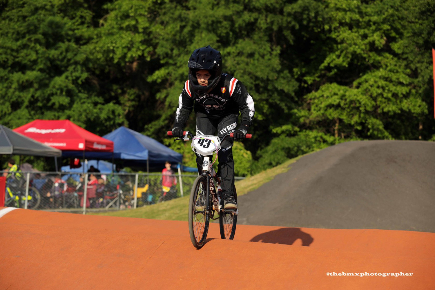 BMX racer railing a berm on race day