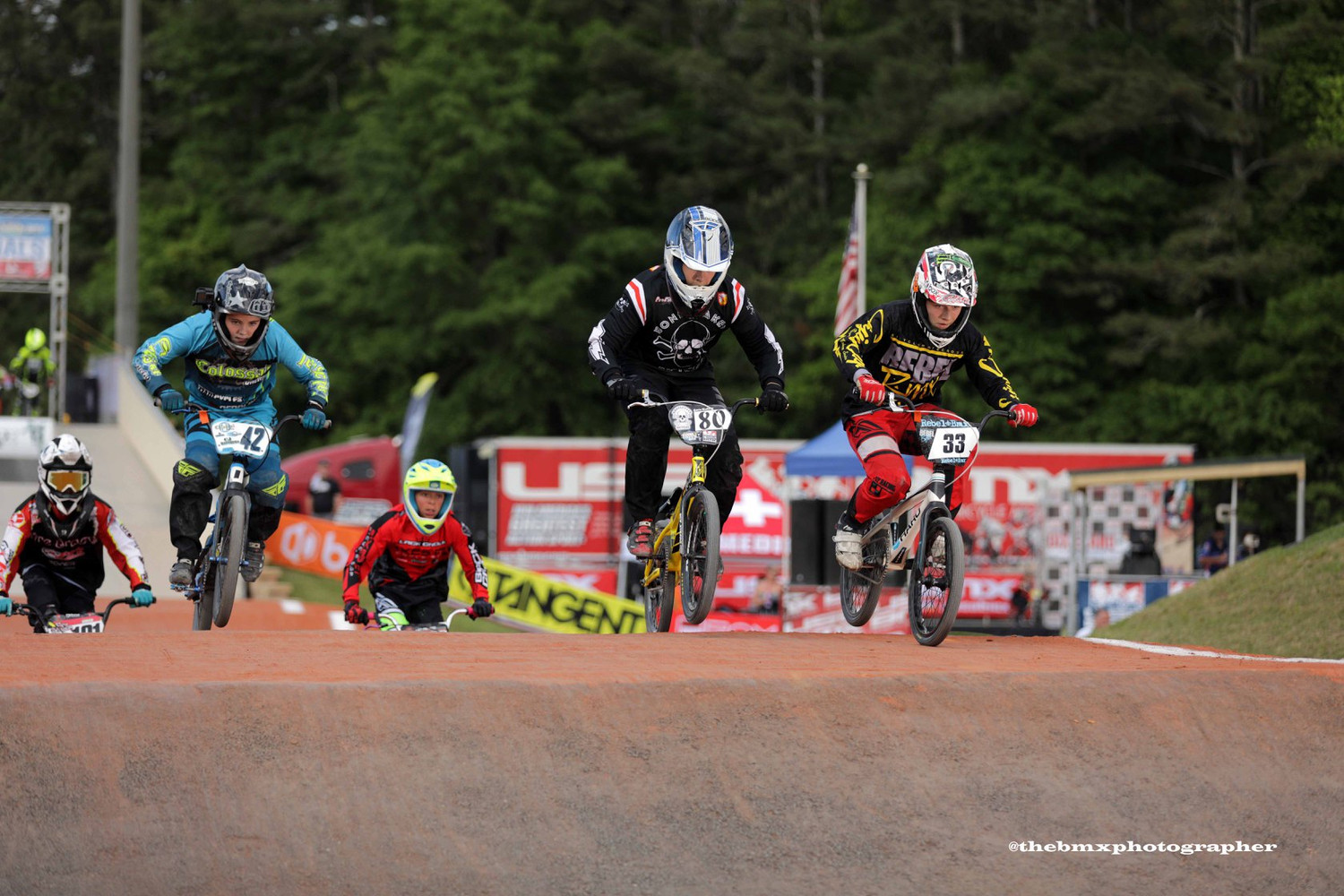 A pack of BMX racers leaving the start gate