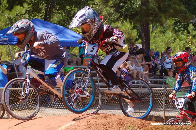 A pack of racers flying over a jump
